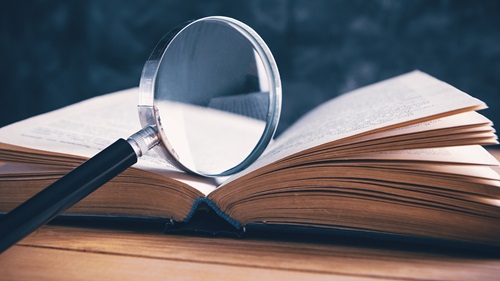 A magnifying glass on top of a book